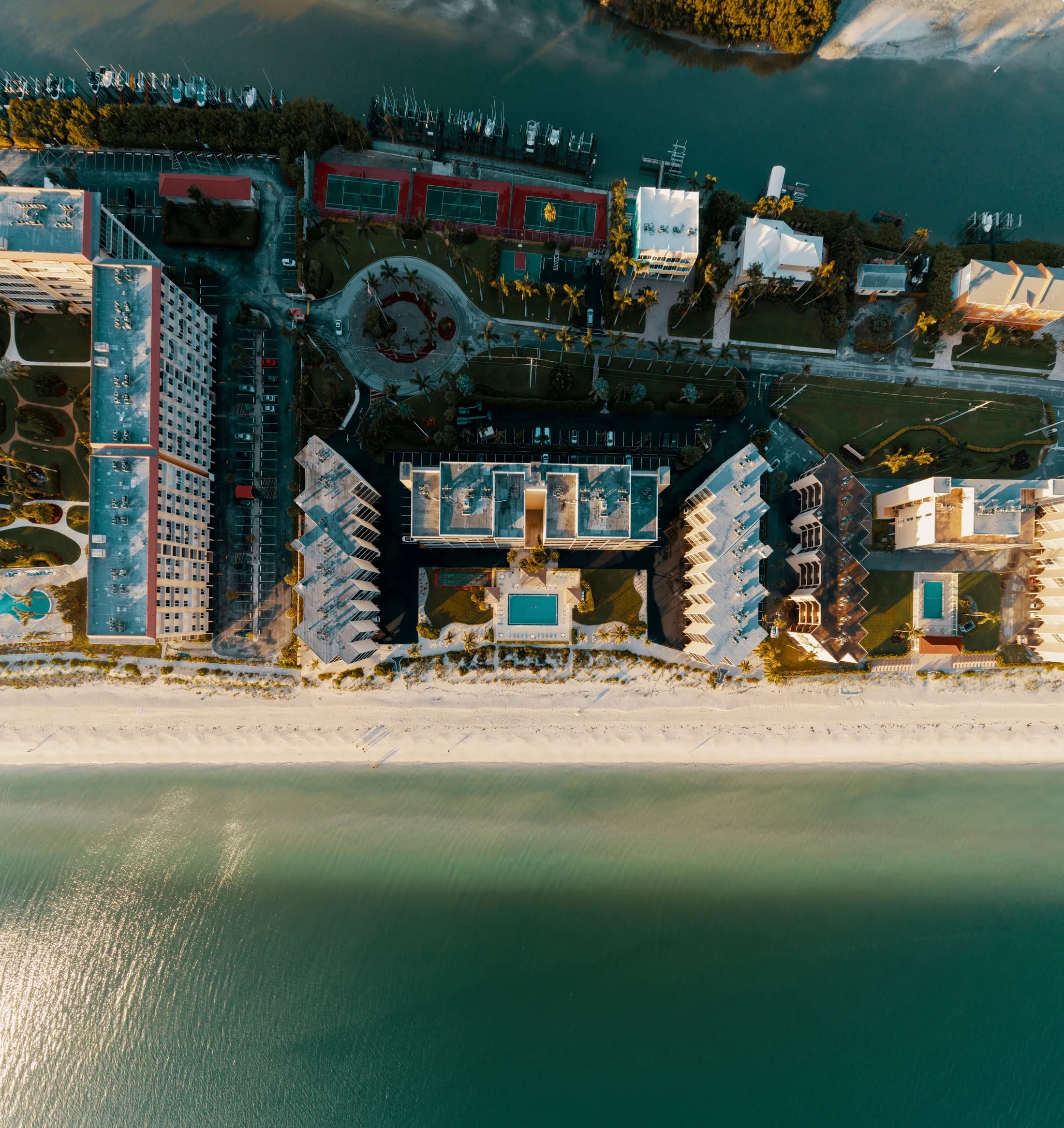 Aerial view of beachfront resorts and white sand in Bonita Springs, Florida.