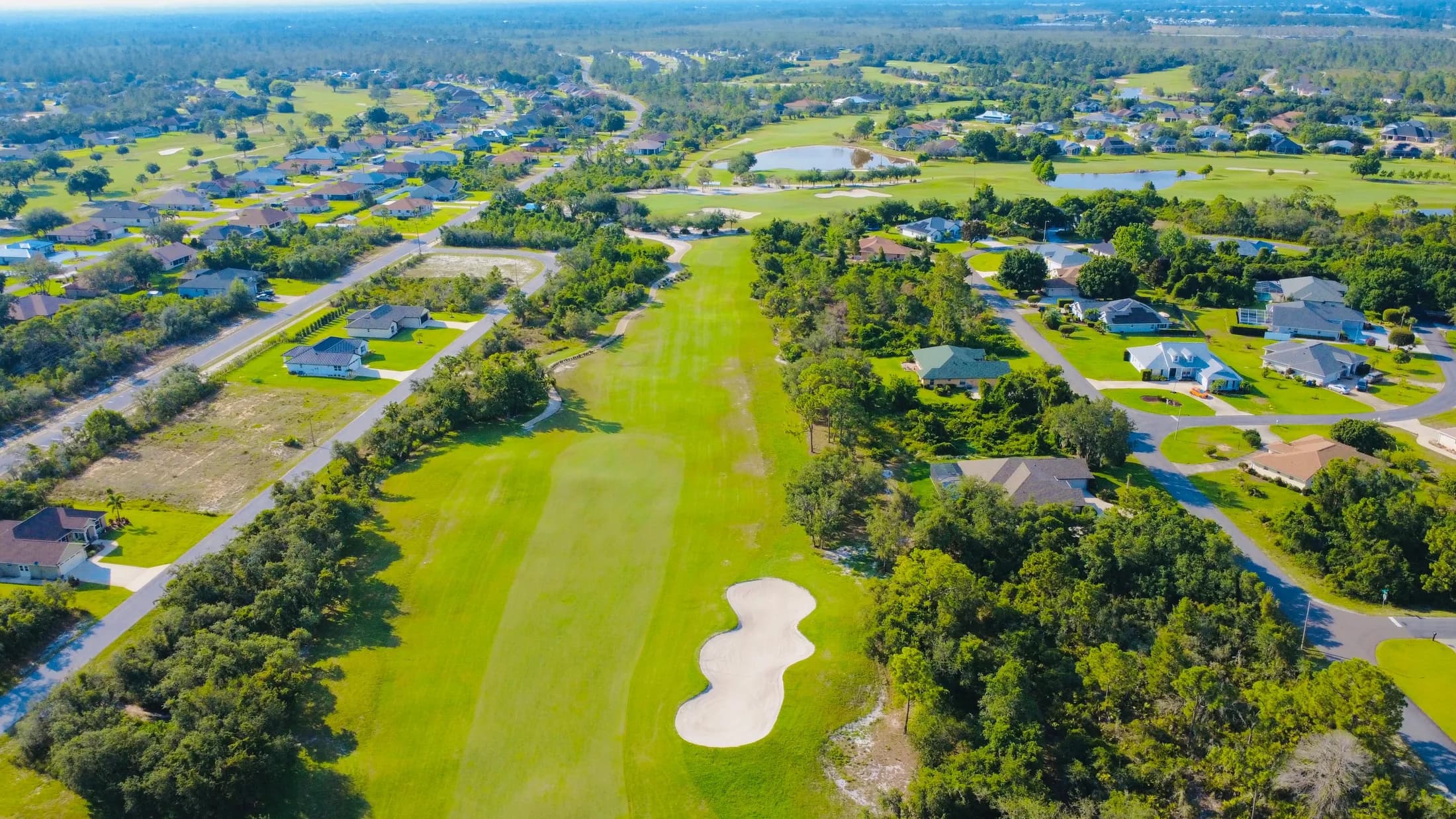 Aerial view of a Florida residential neighborhood surrounding a green golf course.