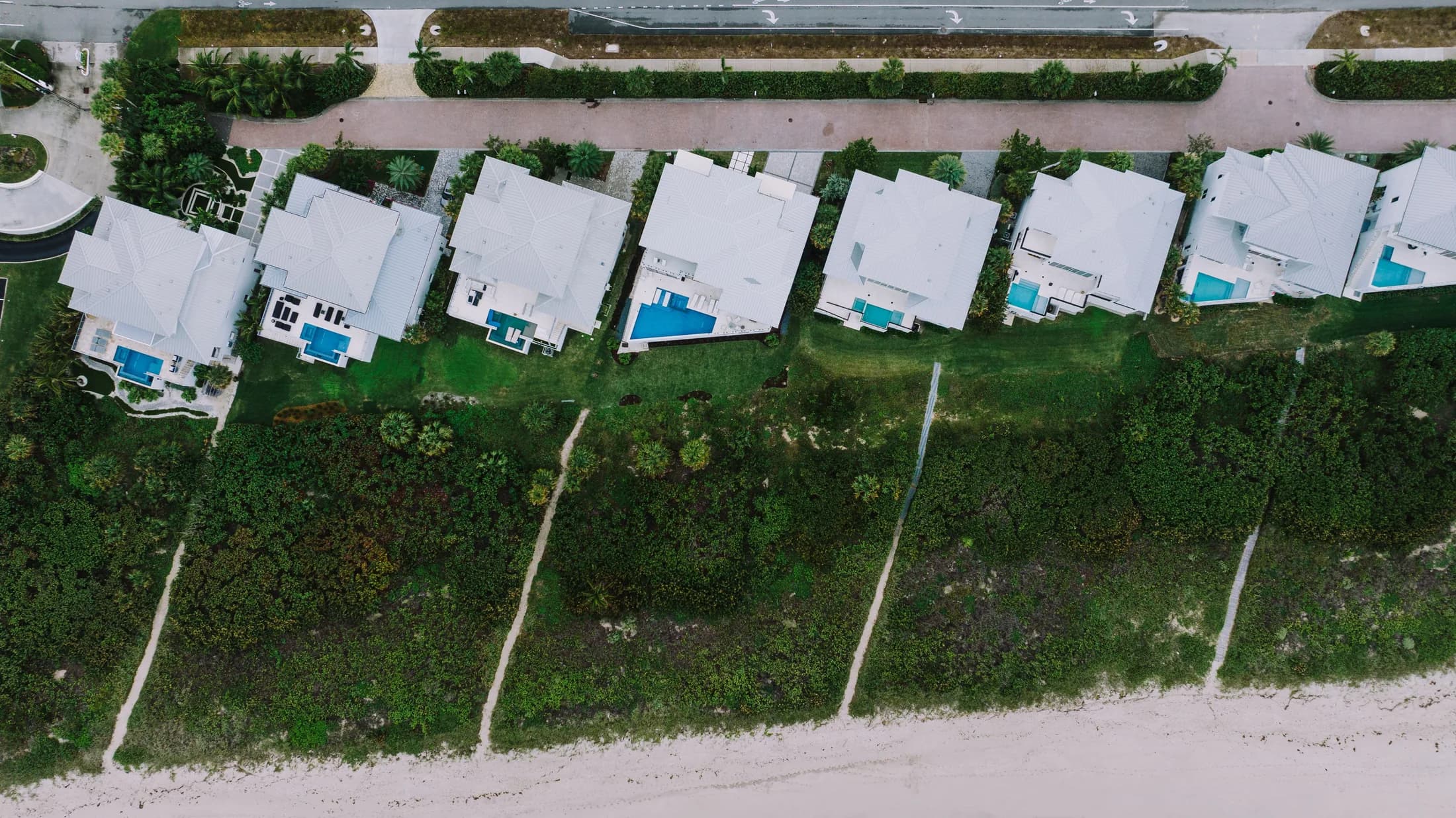 Aerial view of Treasure Coast beachfront homes on a bright, sunny day